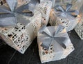 White thread lighted boxes with glittery blue ribbons and bows as indoor and outdoor Christmas decoration displays.