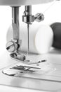 White thread through the needle eye.The side of the sewing machine Royalty Free Stock Photo