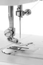 White thread through the needle eye.The side of the sewing machine Royalty Free Stock Photo