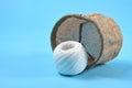 A white thread rolls in front of a fallen sack Royalty Free Stock Photo