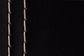 White thread stitching on black leather. Royalty Free Stock Photo