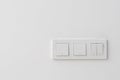 White three light switch panel on hotel wall Royalty Free Stock Photo