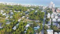 White three-story vacations homes, condo buildings surrounding by lush green trees in beach neighborhood along county road 30A, Royalty Free Stock Photo