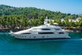 White three-story yacht sailing on the sea off the coast