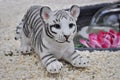 White tiger with white stripes figurine on gray stones natural floor