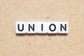 White tile letter with word union on wood background Royalty Free Stock Photo