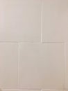 White tile ceramics of a bathroom wall