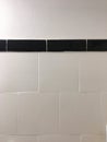 White tile ceramics of a bathroom wall