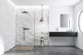 White tile and crude wall bathroom shower and sink
