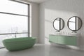 White and tiled bathroom corner with tub and double sink Royalty Free Stock Photo