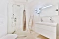 White tiled bathroom with glass shower Royalty Free Stock Photo