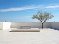 a white tiled patio with a bench and a tree
