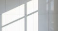 White tiles form a grid pattern, with sunlight streaming through a window, casting long, geometric Royalty Free Stock Photo