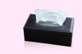 White tissues in a rectangular black leather box placed on pink background, object, decor, modern, copy space Royalty Free Stock Photo