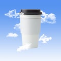 White To Go Coffee Cup with a Black Lid with Clouds and a Blue Sky Background Royalty Free Stock Photo