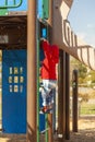 A white toddler boy is playing at a playground alone