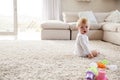 White toddler boy sitting on the floor in sitting room Royalty Free Stock Photo