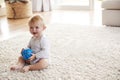White toddler boy sitting on the floor in sitting room Royalty Free Stock Photo
