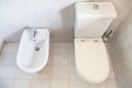White toilet with bowl drain and bidet Royalty Free Stock Photo