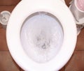 The white toilet bowl with stream water in bathroom Royalty Free Stock Photo