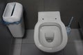 White toilet with hygienic bucket in public toilet sanitary room