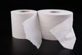 White toilet paper on a dark table. Articles for daily hygiene