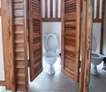 White toilet in teak rest room