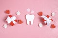 White tooth with gifts, hearts and roses on a pink background. Dental Valentine card