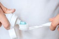 Morning brushing, squeezing toothpaste onto a toothbrush Royalty Free Stock Photo