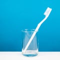 The white toothbrush with small glass Royalty Free Stock Photo