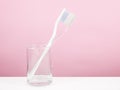 The white toothbrush with small glass Royalty Free Stock Photo