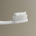 A white toothbrush with a soft bristle head, holding a dollop of white toothpaste. The Royalty Free Stock Photo