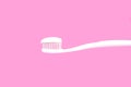 White toothbrush with toothpaste on pink background Royalty Free Stock Photo