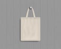 White tote on wood wall. Mockup of eco canvas bag with handle. Cotton fabric tote. Reusable cloth of ecobag for shopping, grocery Royalty Free Stock Photo
