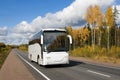 white tourist bus on autumn country highway Royalty Free Stock Photo