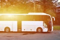 White tourist bus for excursions. The bus is parked in a parking lot near the park