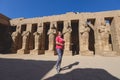 White Tourist looking at the Ancient Massive Columns of Karnak Temple Complex in the Great Hypostyle Hall in the Precinct of Amun- Royalty Free Stock Photo