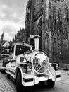 White tourist train parked at the foot of the Strasbourg Cathedral in France