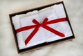 White towel gift in leather box on artificial fur background