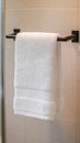 White towel hanging on black bar in modern bathroom Royalty Free Stock Photo
