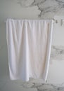 White towel hangs against wall in the bathroom Royalty Free Stock Photo