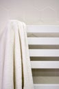 A white towel hangs on a heated towel rail in the bathroom Royalty Free Stock Photo