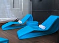 White Towels on Blue Plastic Chaise Lounges Royalty Free Stock Photo