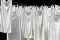 White towels hanging on clothesline isolated on black Royalty Free Stock Photo