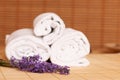 White towels and massage rocks in spa salon over dark and light Royalty Free Stock Photo