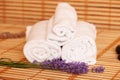 White towels and massage rocks in spa salon over dark and light Royalty Free Stock Photo