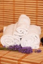 White towels and massage rocks in spa salon over dark and light Royalty Free Stock Photo