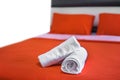 White towels roll up on bed in hotel bedroom Royalty Free Stock Photo