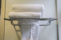 Towels on the stainless shelf in luxury bathroom in hotel