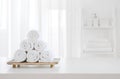 White towels on wooden pedestal over blurred spa room background